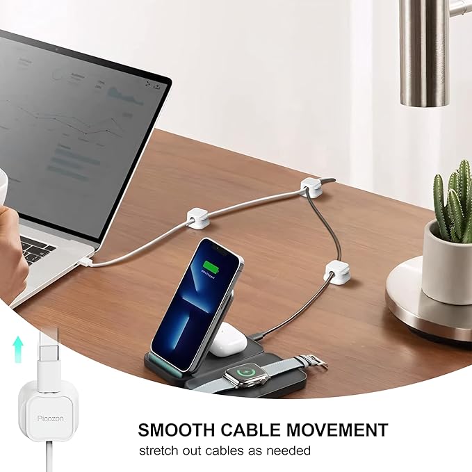 Desk setup with a laptop, phone, and smartwatch on a charging stand with smooth cable movement feature.