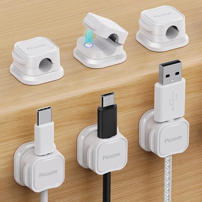 Set of white cable organizers with different connectors on a wooden surface