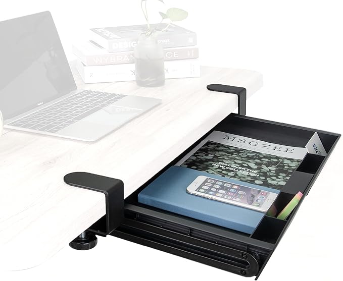 Black adjustable desk tray with magazine and smartphone on a white desk with laptop